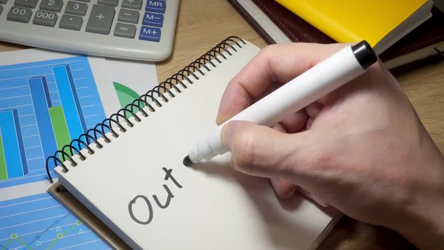 Man writing Outsourcing at note.