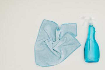 top view of blue rag and spray bottle isolated on white