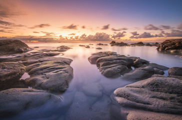 Fototapeta na wymiar Long expose seascape with stunning sunset colors. 