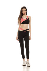 young woman in sportswear on white background