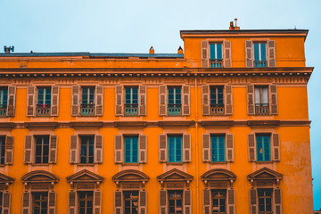 Fototapeta na wymiar big residential building with orange facade in darken tones