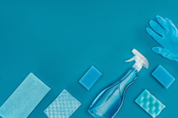 top view of spray bottle with blue washing sponges isolated on blue