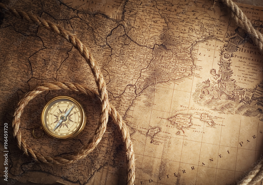 Aufkleber old vintage retro compass on ancient map background. travel geography navigation concept background.