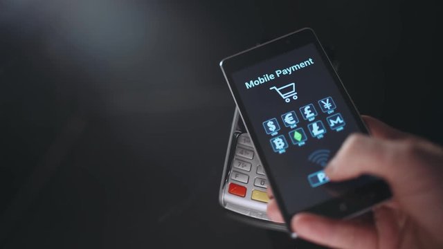 Man makes a payment with smartphone, NFC terminal, ethereum payment mode.
