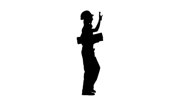 Construction worker wearing a helmet carries three wooden boards. Silhouette. White background. Side view