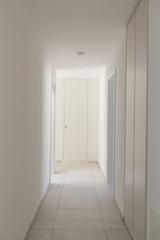 White empty corridor with many closets