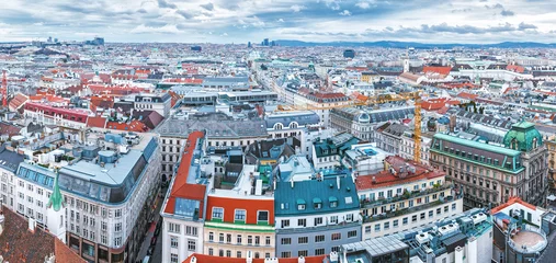 Fototapeten Vienna, Austria, Europe. Lovely skyline view from above of Vienna. Iconic landmark and extremely popular European travel destination. View over roofs on classic architecture, day scenery. © Feel good studio