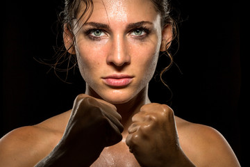 Female empowering inspiring motivational portrait of female fighter in self defense stance 