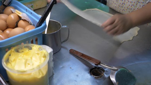Banana pancake fried in hot pan in Thailand, Rotee of street food. 4k
