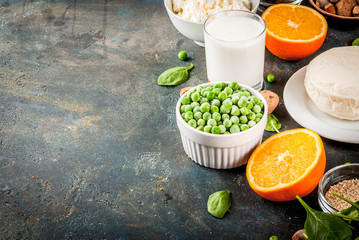 Healthy food concept. Set of food rich in calcium - dairy and vegan Ca products, dark blue background copy space