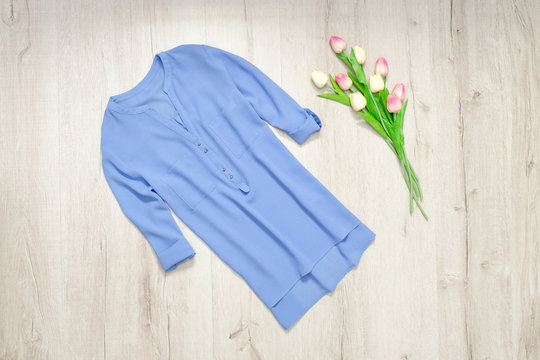 Blue blouse, bouquet of tulips. Fashionable concept © somemeans