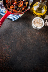 Roasted or grilled beef liver with onion and carrot in portioned frying pan, dark rusty  table copy space