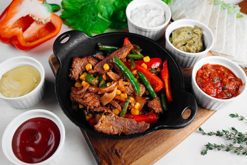 meat with vegetables in a frying pan