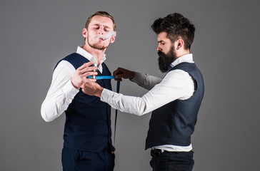 Tailor taking measurements for sewing, grey background.