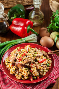 Fried rice with chicken and vegetables served on a plate