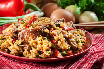 Fried rice with chicken and vegetables served on a plate