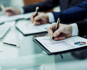 closeup of business team is working with the financial schedules in the workplace in the office