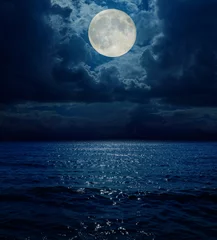 Zelfklevend Fotobehang super maan in donkere wolken boven zee © Mykola Mazuryk