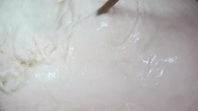 mixing milk in the cauldron- Making cheese-Diary cheese factory