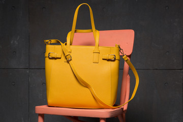 yellow fashion bag on a pink chair, shopping concept