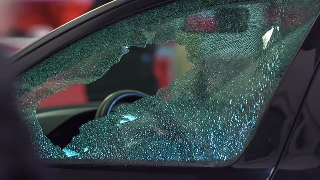 There is a broken glass window and a big hole in it. The vehicle will be fixed at a car repair shop.