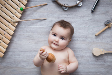 beautiful baby surrounded by several instruments