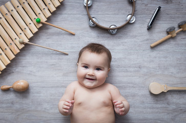 beautiful baby surrounded by several instruments