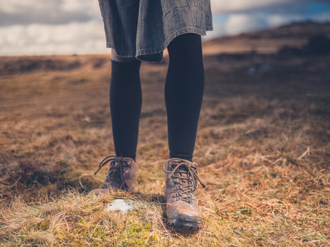 Legs and feet of woman walking on moor