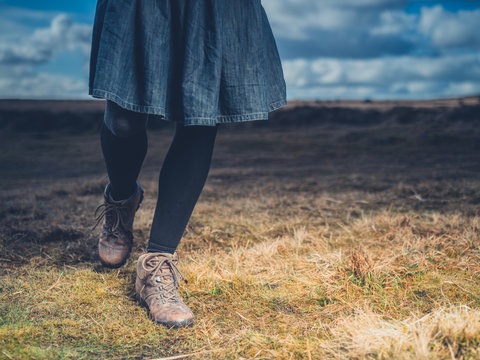 Legs and feet of woman walking on moor