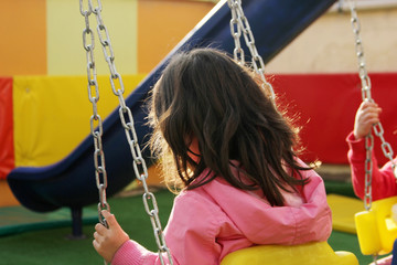 Little girl enjoying swinging 