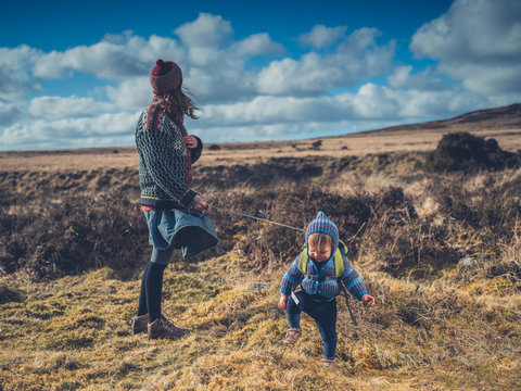 Young mother walking on the moor with her toddler