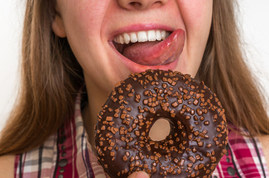 Woman is eating a delicious donut