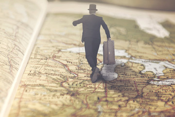 surreal businessman runs over a giant map towards a lucrative job