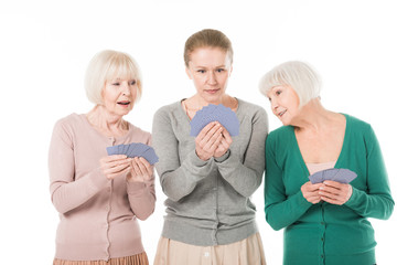 Three stylish women playing cards isolated on white