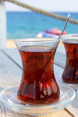 Cup of black Turkish tea and traditional asian sweets.