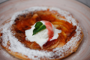 Apple pie on the plate with vanilla ice cream. Restaurant food. Traditional desert. Cooking at home.