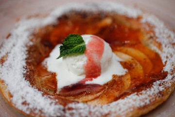 Apple pie on the plate with vanilla ice cream. Restaurant food. Traditional desert. Cooking at home.