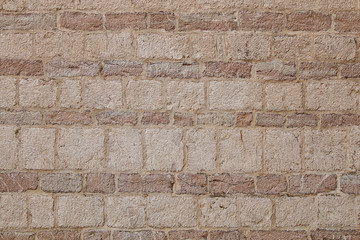 The texture of the stones and cobblestones. Fragment of the old fortress wall.