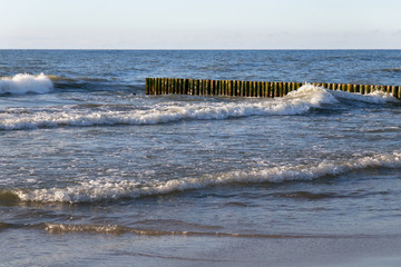 Old german breakwater on the Baltic Sea coast in spring.