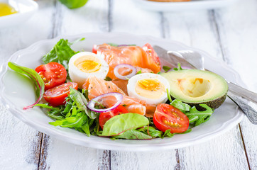 Smoked salmon salad with greens, tomatoes, eggs and avocado