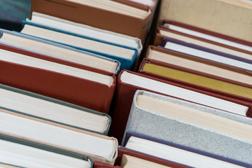 Many books in a bookstore or library on wooden background with copy space