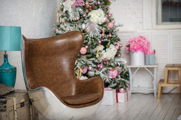 Christmas Tree and Christmas gift boxes in the interior with a fireplace.