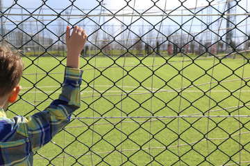 Child in front of the football field