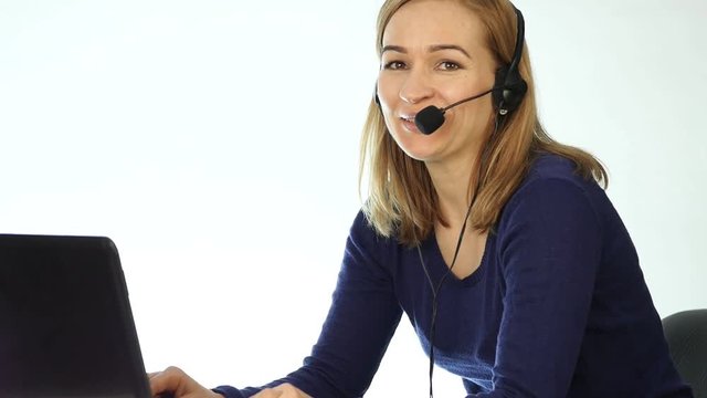 call center representative talking on helpline, Headset telemarketing positive female call center agent at work. slow motion