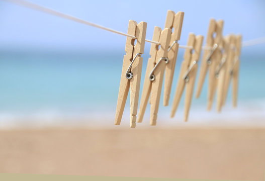 Clothes pegs on a washing line by the beach