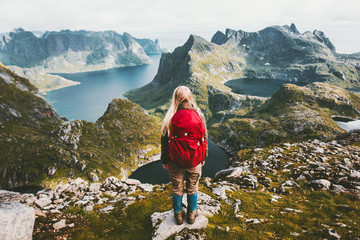 Woman alone with backpack exploring mountains of Norway Traveling healthy lifestyle adventure...