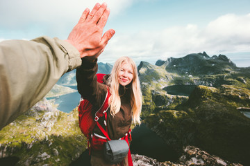 Happy couple friends giving five hands hiking in mountains Travel Lifestyle positive emotions...