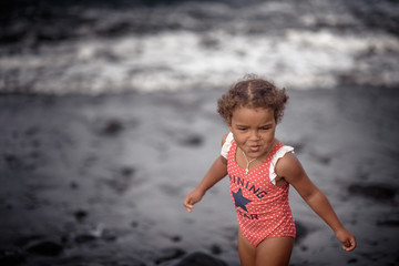 Fototapeta na wymiar Happy girl jumping on the beach on the dawn time