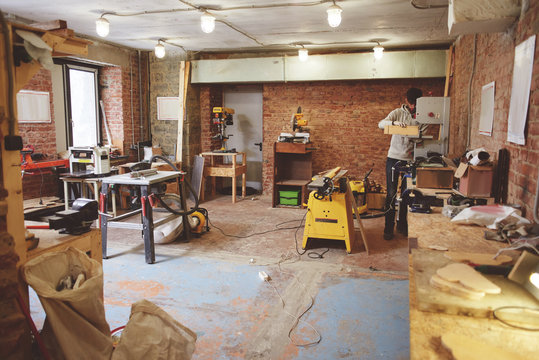 The young carpenter works in a workshop