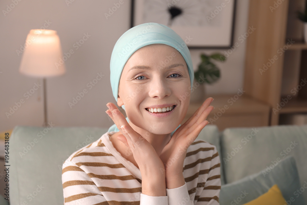 Wall mural young woman with cancer in headscarf indoors